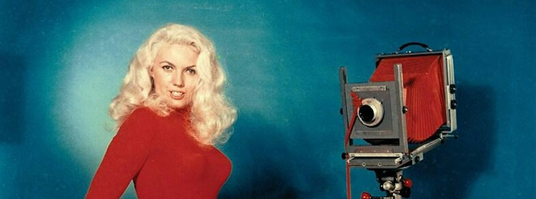 Photographer making self portrait of themselves with a large format camera