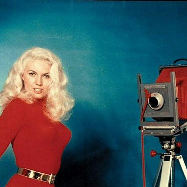 Photographer making self portrait of themselves with a large format camera