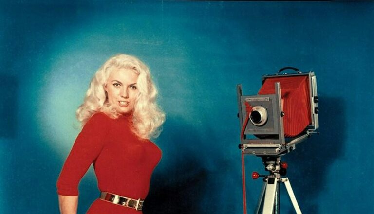 Photographer making self portrait of themselves with a large format camera